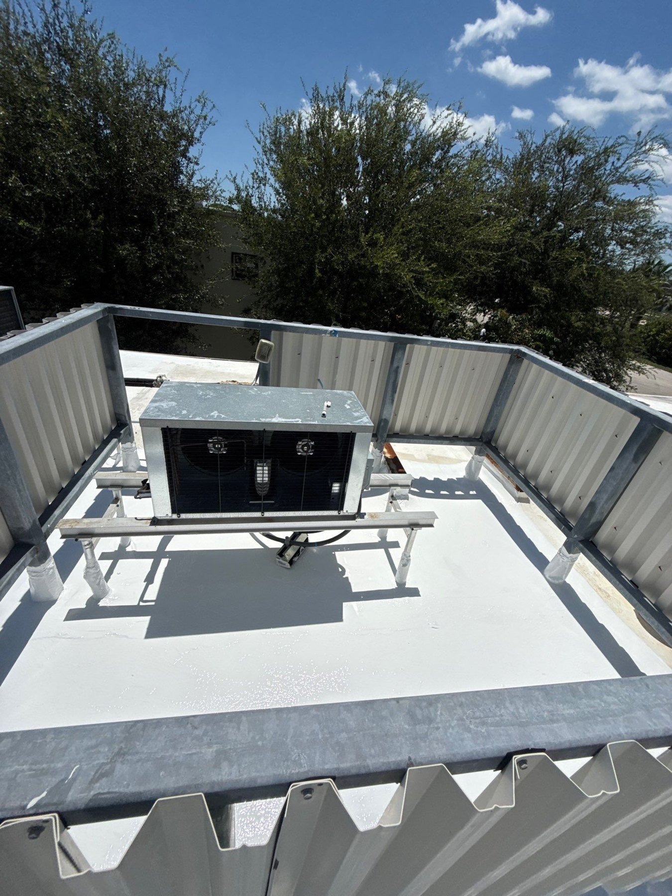 Flat roof maintenance view around rooftop equipment and roof edges