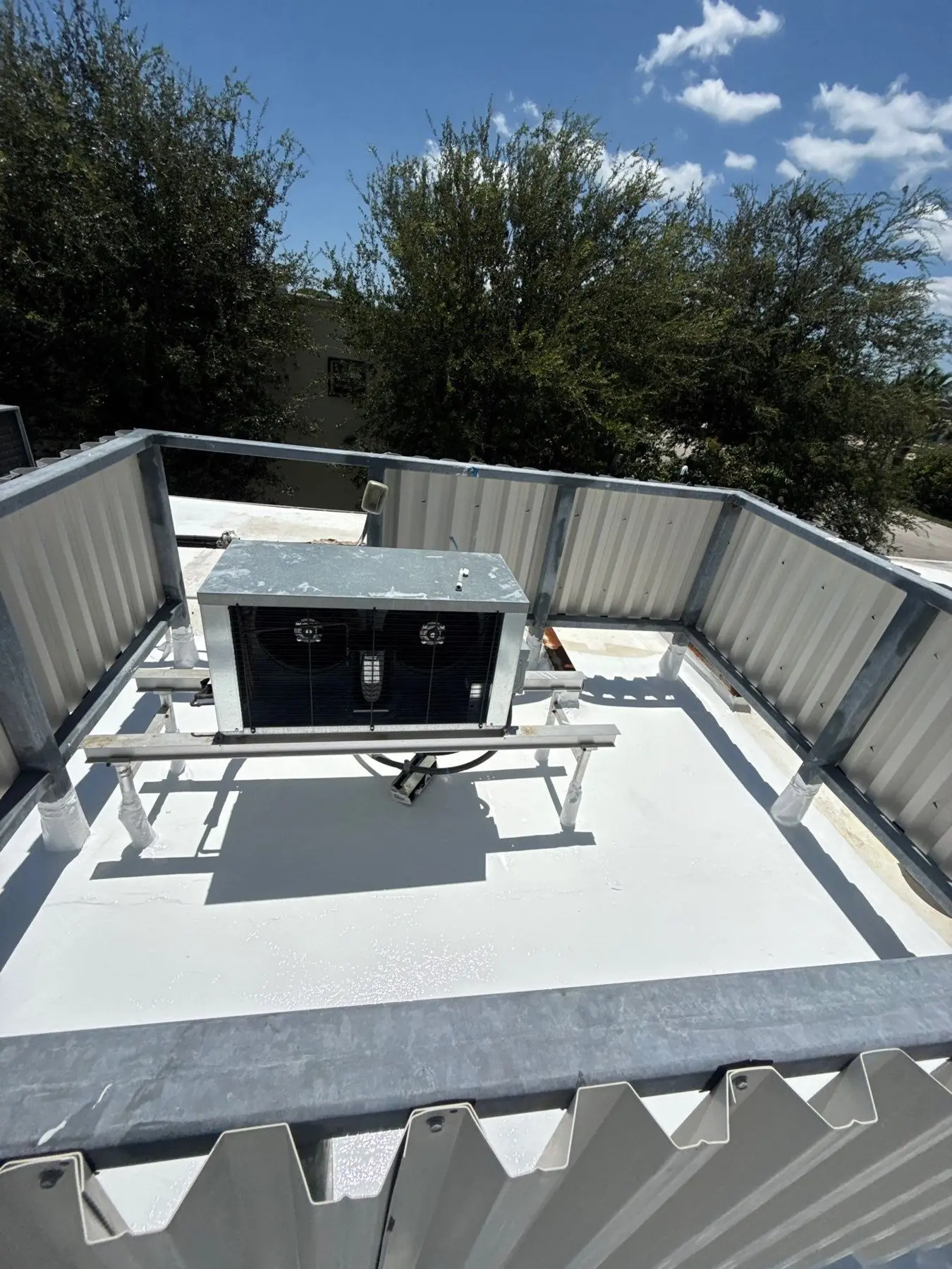 Flat roof maintenance view around rooftop equipment and roof edges