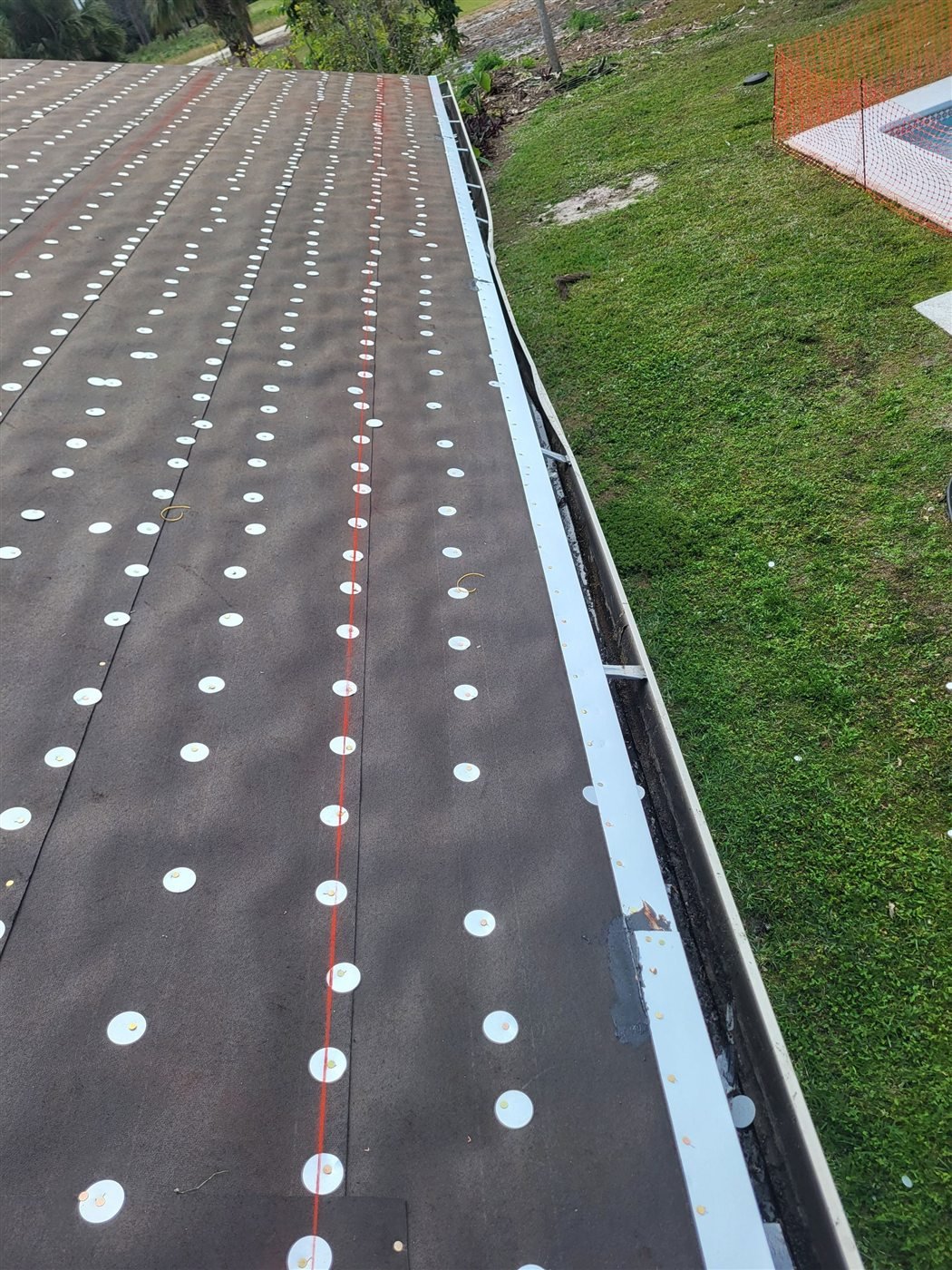 Mechanically fastened roof underlayment during a Wellington roof replacement