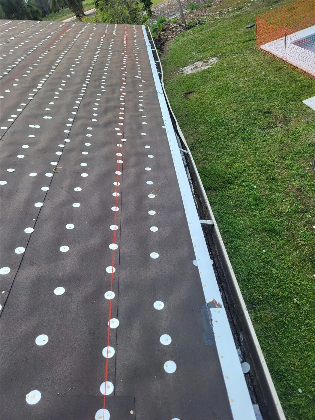 Mechanically fastened roof underlayment during a Wellington roof replacement